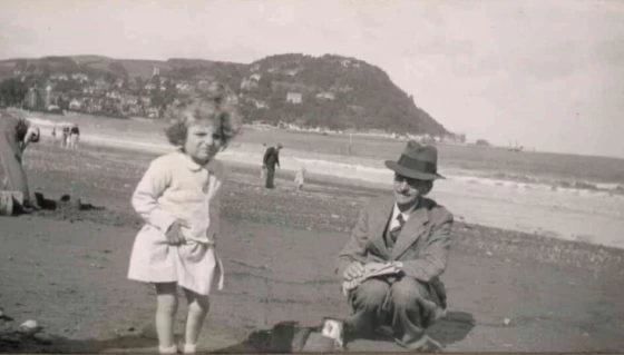 Francis Turner on the beach at Minehead with his granddaughter
