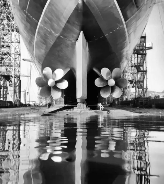 Photograph of stern view of the Cunard liner RMS Queen Elizabeth 2 showing propellers during construction at the shipyard of John Brown and Company, Clydebank. 
Image courtesy of National Records of Scotland.