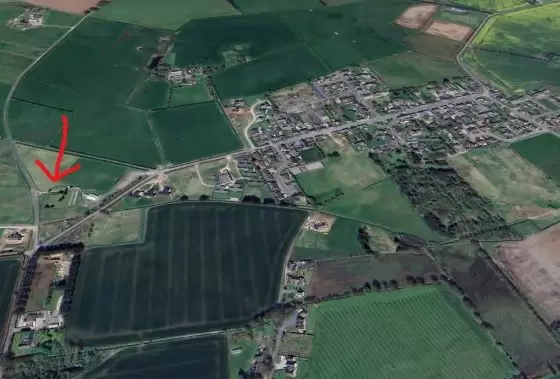 Aerial photo of Fetterangus. The graveyard is marked with a red arrow.